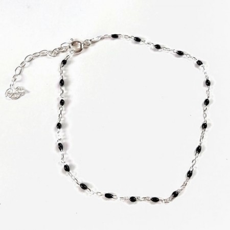 Sterling silver anklet with black beads on ankle
