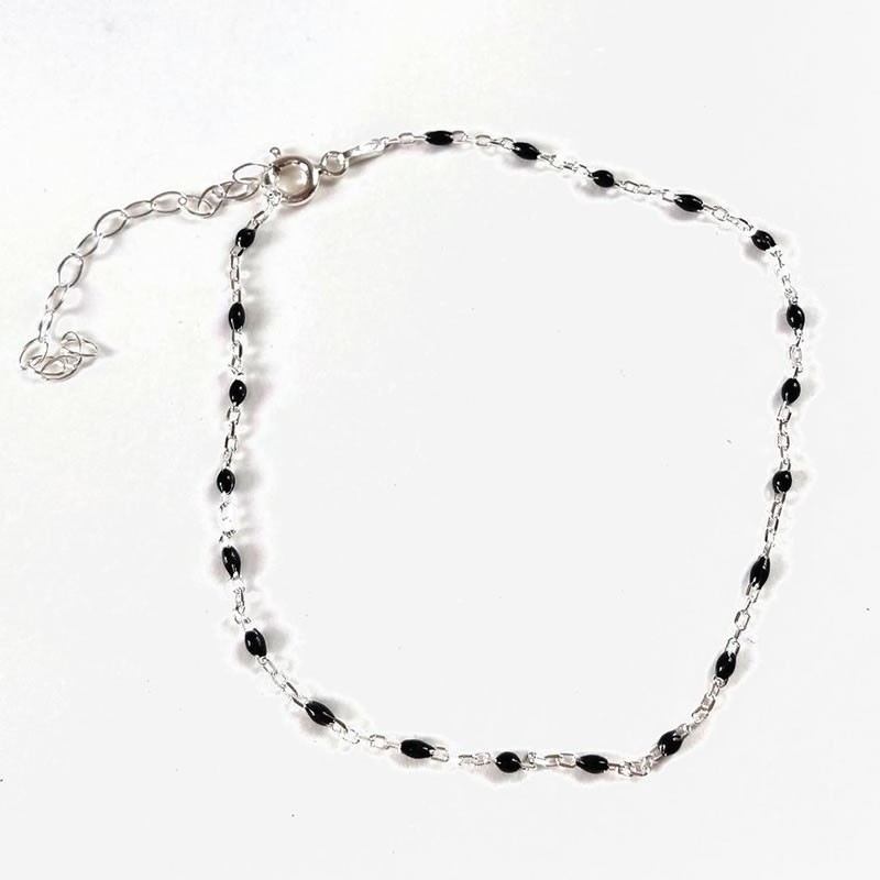 Sterling silver anklet with black beads on ankle