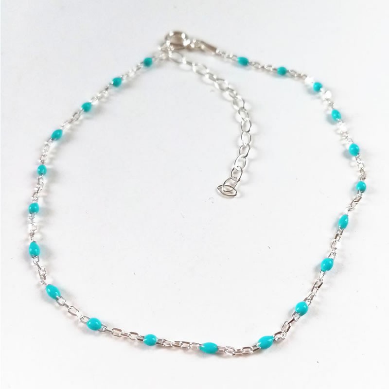 Sterling silver anklet with blue beads on ankle