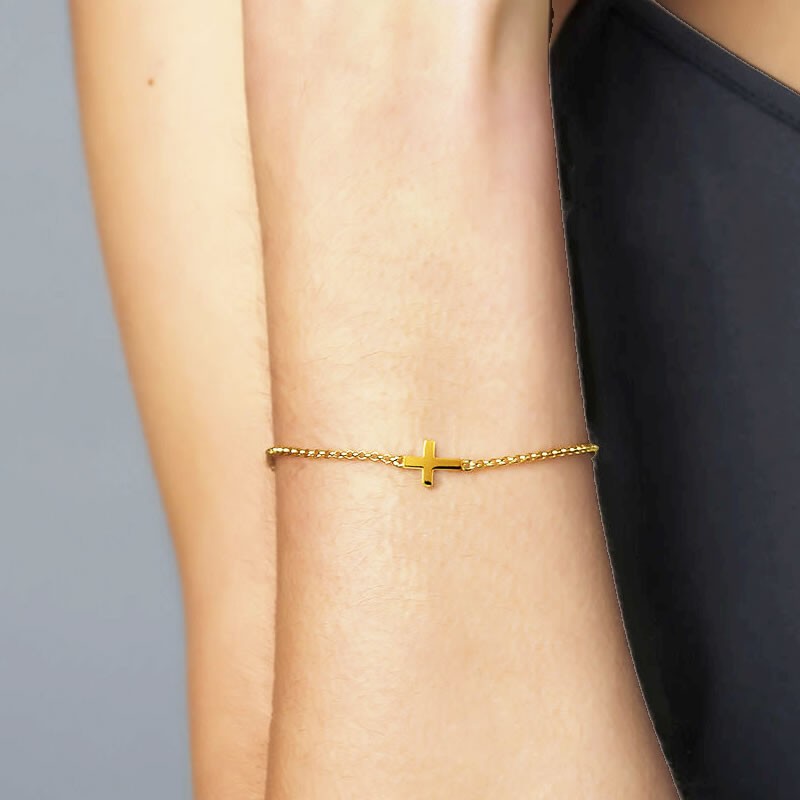 pulsera cruz tumbada oro