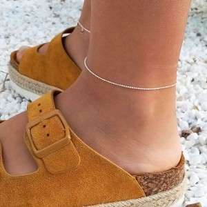 Silver anklet styled with casual footwear