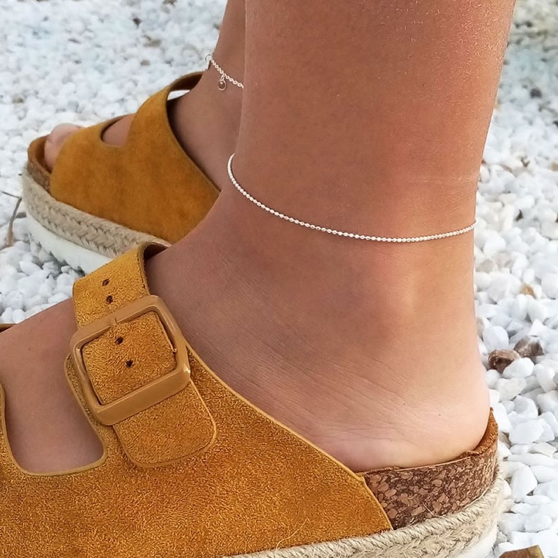 Silver anklet styled with casual footwear