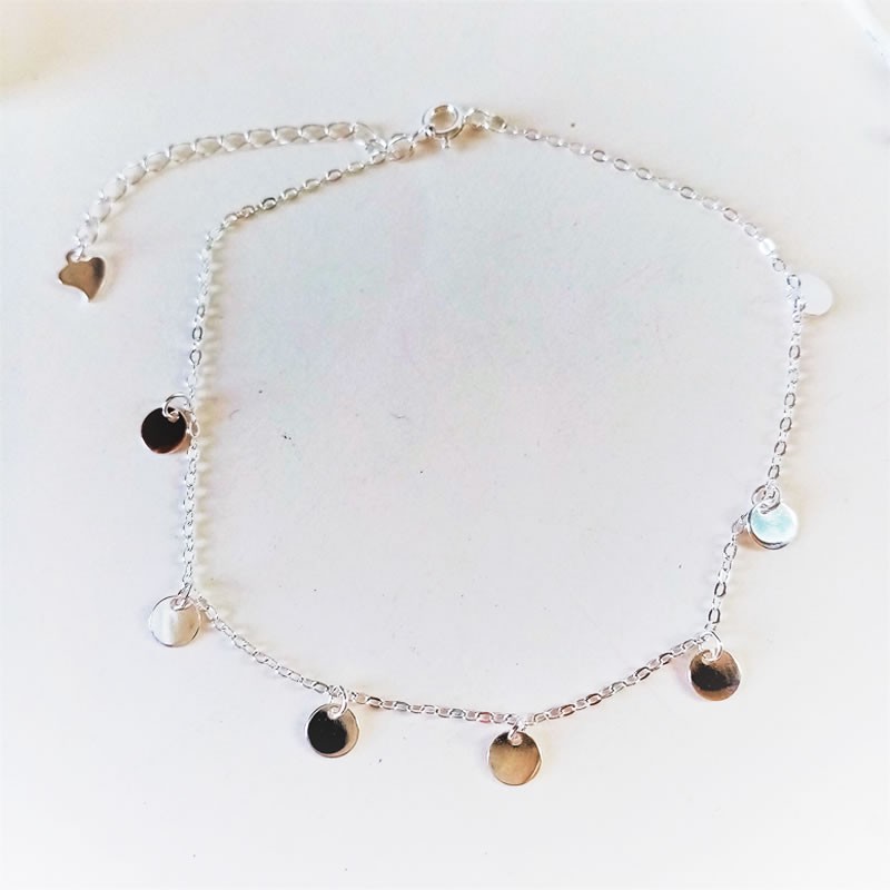 Youthful anklet in sterling silver with hanging charms.