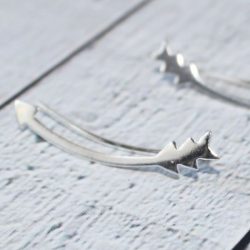 Side view of the arrow climber earrings, one for each ear