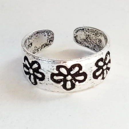 Close-up of the open ring with engraved flowers